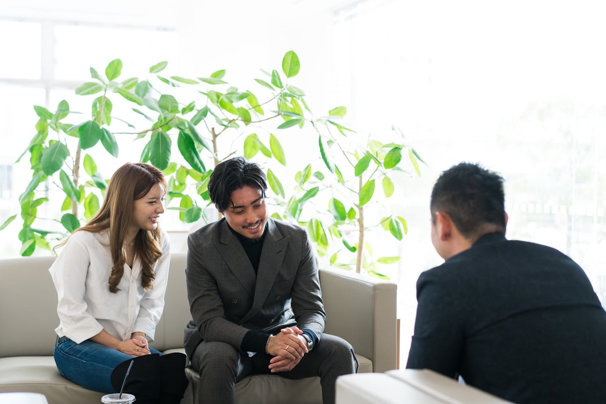 Couple Chatting with Car Salesperson